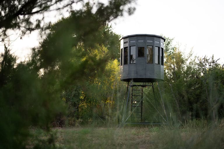 360 Pro hunting blind in a natural setting, green exterior, side view