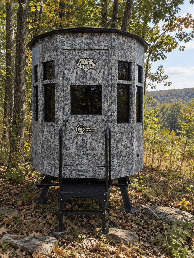 360 Chasing Giants Asio Version hunting blind in camo pattern, positioned on a wooded area with autumn foliage.