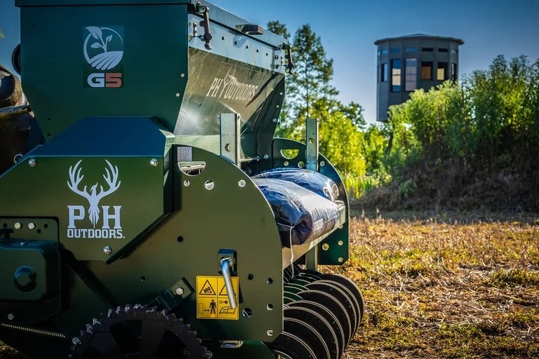 360 Pro XL hunting blind in green, rear view with attachments visible, background shows wooded area.