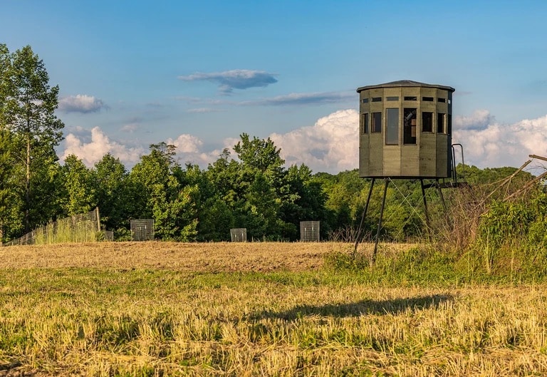 360 Pro XL hunting blind in green and brown, elevated view from the side on a clear day.