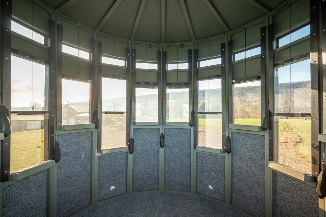 Interior view of the 360 Pro XL hunting blind showing multiple windows and gray walls.